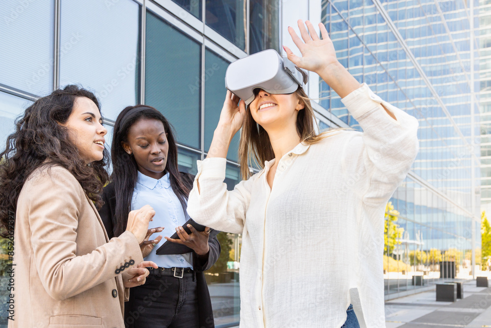 Three women testing virtual reality technology outdoors Three women testing virtual reality technology outdoors