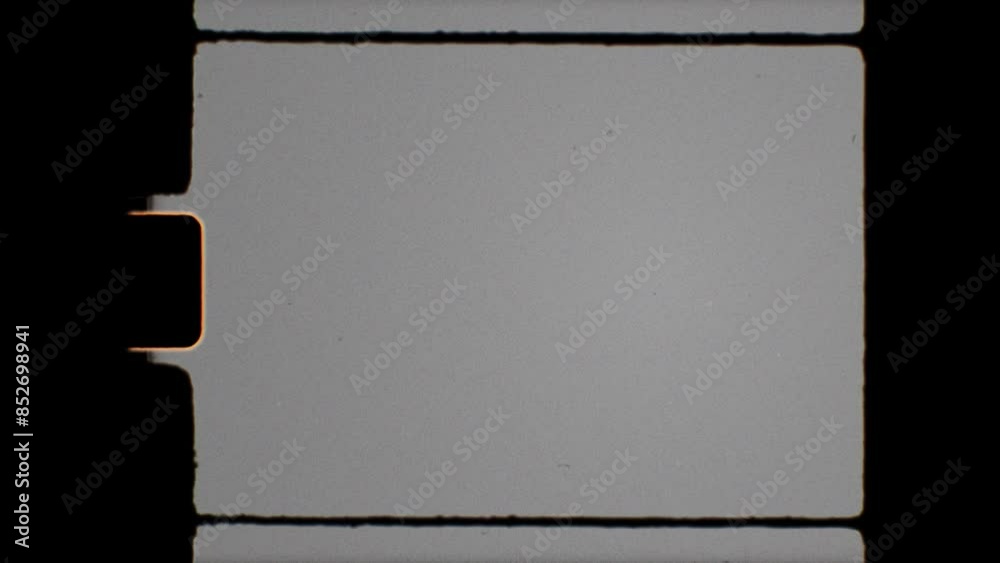 Vintage 8mm film frame with a blank, grey screen and black edges. Classic Super8 film reel effect for retro projects. Use 'Hard Light' blending mode
