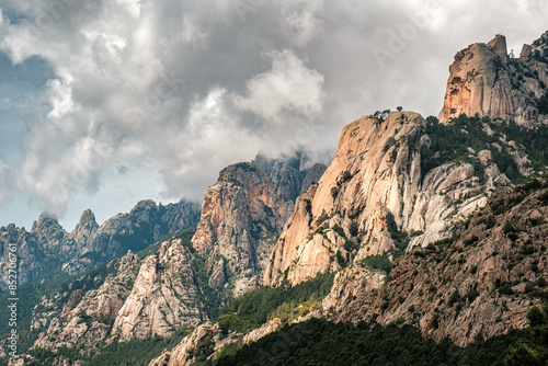 Dark clouds over the Aiguilles de Bavella, needle like rocky mountain peaks surrounded by pine forest and maquis in the centre of Corsica