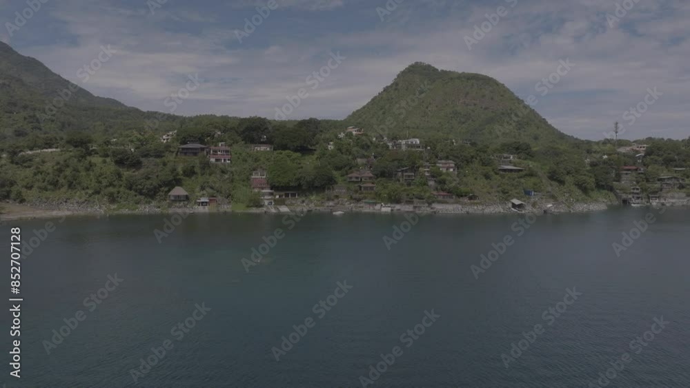 beautiful wide drone shot of lake atitlan showing many houses on the water during summer beautiful wide drone shot of lake atitlan showing many houses on the water during summer