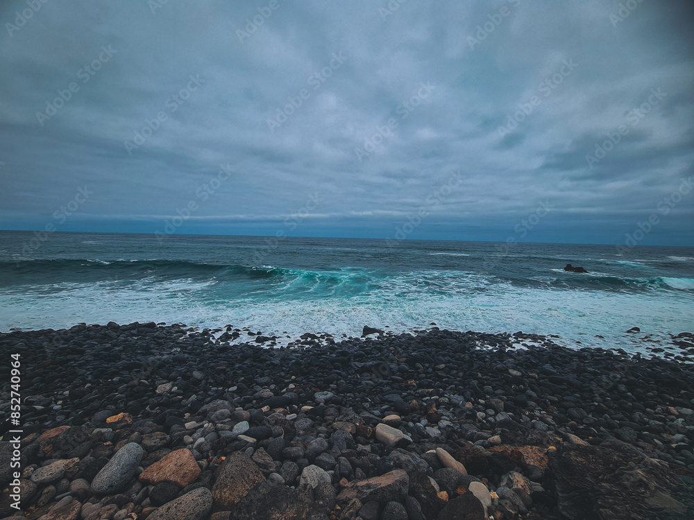 Coastal View: Volcanic Rocks with Blue Sea Coastal View: Volcanic Rocks with Blue Sea