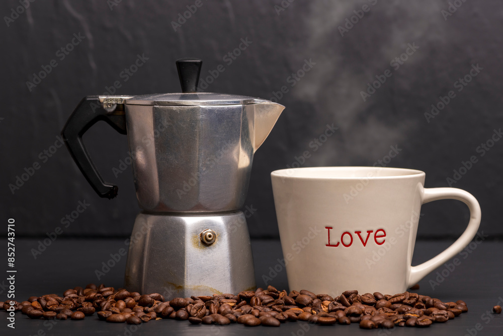 Coffee mug with Love written on it. Coffee pot with roasted beans. Coffee mug with Love written on it. Coffee pot with roasted beans.