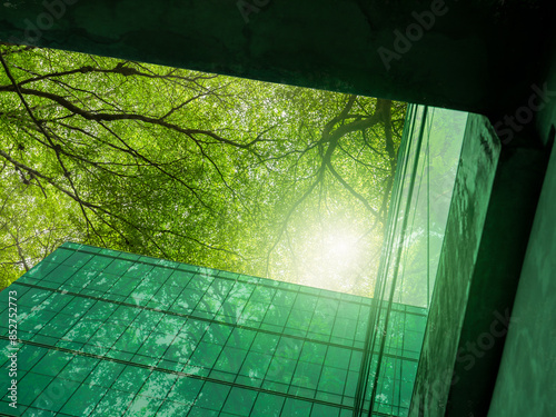 Eco-friendly building in the modern city. Sustainable glass office building with trees for reducing heat and carbon dioxide. Office building with green environment. Corporate building reduce CO2.