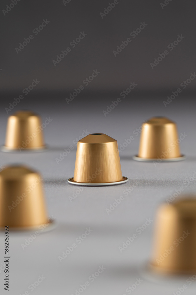 Coffee capsules in focus with others blurred in the background, creating a sense of depth Coffee capsules in focus with others blurred in the background, creating a sense of depth