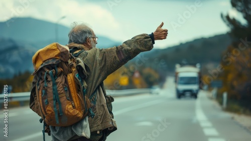 a man with a backpack on his back is pointing at the road photo