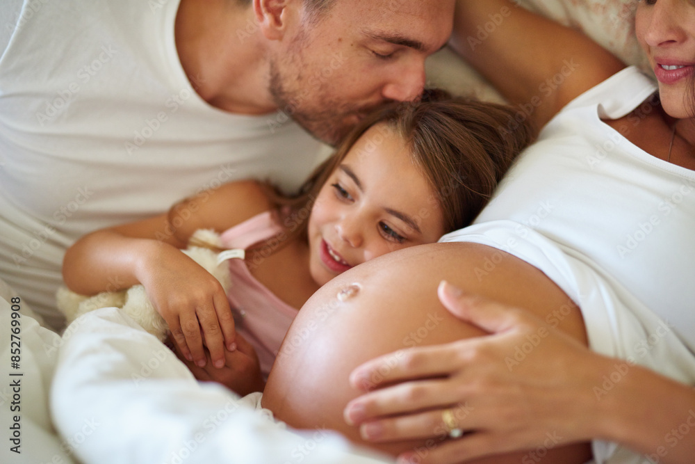 Child, pregnancy and happy family on bed with love, support and daughter in morning. Girl, parents and kiss in bedroom for growth, safety and security at home with happiness, affection and care
