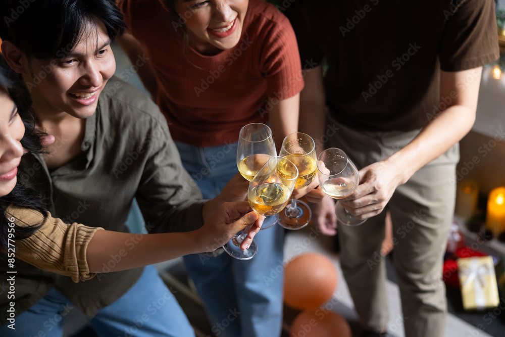 Close up hand holding glass. Group of young asian people smiling friends drinking at birthday party toast with beer. food and beverag Close up hand holding glass. Group of young asian people smiling friends drinking at birthday party toast with beer. food and beverag