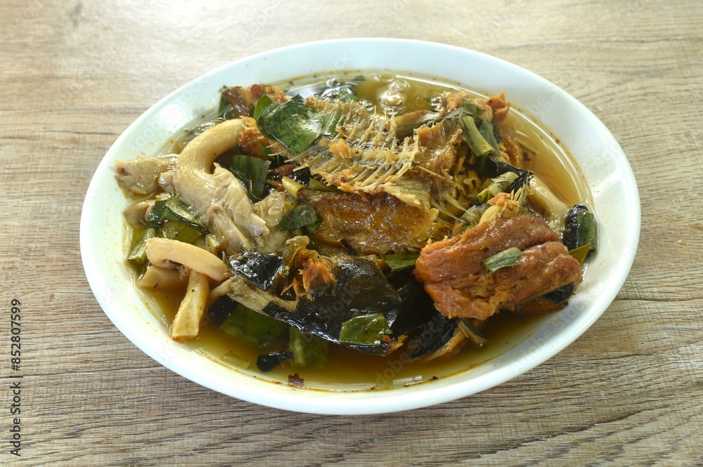 boiled smoked dry snake head fish in spicy and sour soup on plate boiled smoked dry snake head fish in spicy and sour soup on plate