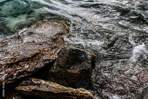 Sea stones on the beach in the sand. Sea landscape. 