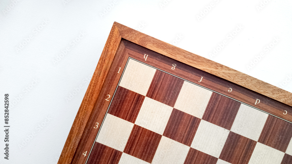 Fototapeta premium Empty wooden chessboard with coordinates isolated on a white background, concept related to strategy games, chess tournaments, and International Chess Day