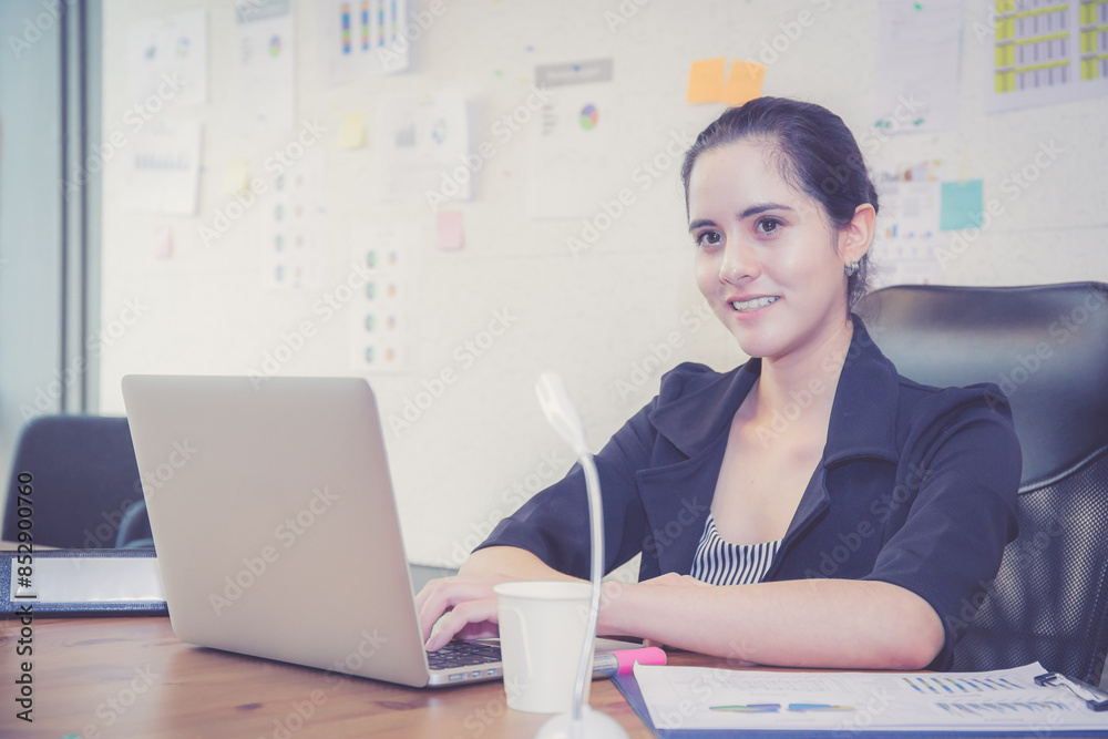 Young caucasian woman sitting and using laptop computer planning for success in modern office, businesswoman typing and watching notebook with confident, employee working on desk, business concept. Young caucasian woman sitting and using laptop computer planning for success in modern office, businesswoman typing and watching notebook with confident, employee working on desk, business concept.