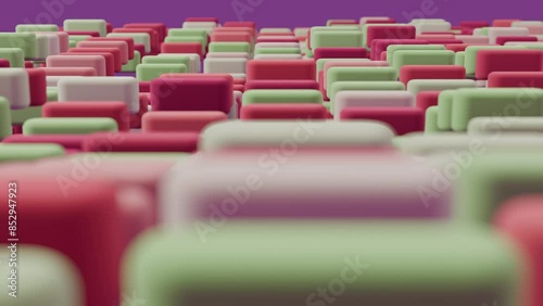 Abstract animation of vertically moving smoothed cubes in red shades on a pink background