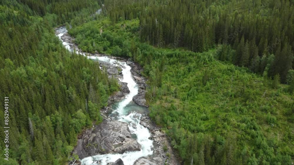 long rapid mountain stream with waterfall going though dense green norwegian forest in summertime, aerial full frame background video long rapid mountain stream with waterfall going though dense green norwegian forest in summertime, aerial full frame background video