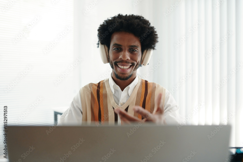 Fototapeta premium Portrait of cheerful entrepreneurs talking to coworkers in online meeting