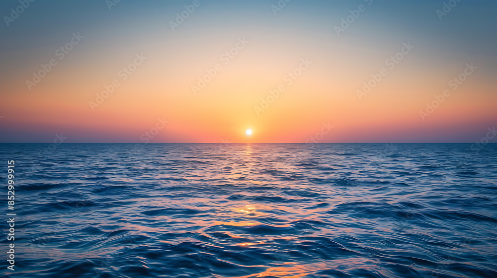 Fototapeta premium Sunrise amidst the ocean, wallpaper, the first light of the day passes through the beautiful waters.