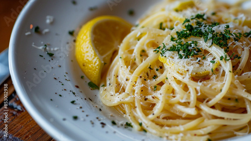 Pasta with a zesty lemon sauce, often accompanied by fresh herbs, al dente spaghetti glistening with a vibrant yellow sauce and topped with basil and parsley, bright and airy modern kitchen.