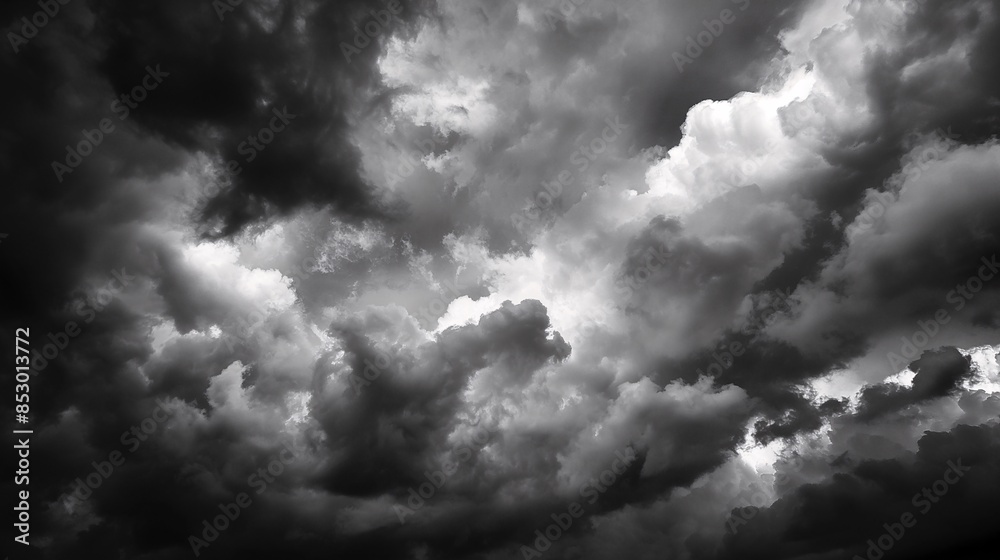 Obraz premium Dramatic black and white photo of stormy clouds gathering in the sky, evoking a sense of impending weather and atmospheric tension.
