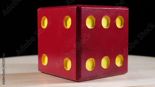 yellow and red big wooden dice rotates on the turntable. 4k video shooting