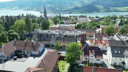 Sunny Lillehammer city center, overflight at low altitude towards Lillehammer church and Hammartun school and Mjøsa