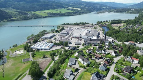 Flying over Strandtorget shopping center. New McDonald's is under construction. Green water in the Lågen delta in the background with an outlet in Mjøsa