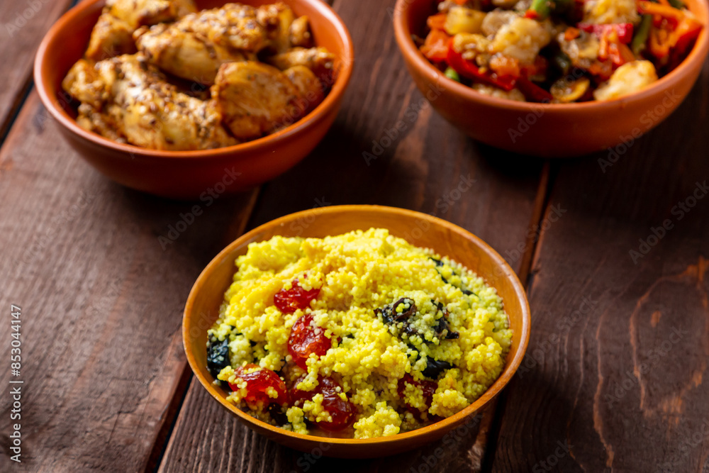 Couscous with chicken and stewed vegetables with meat on the festive table Couscous with chicken and stewed vegetables with meat on the festive table