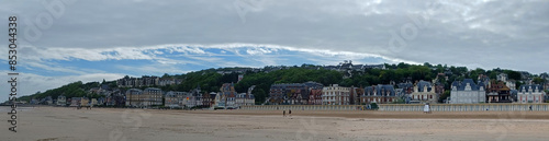 Panoramic view of Trouville coastline with typical norman architecture luxury buildings along the sandy beach. Famous resort and fishermen village in Normandy.