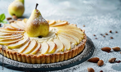 Pear frangipane tart on a light blue surface photo