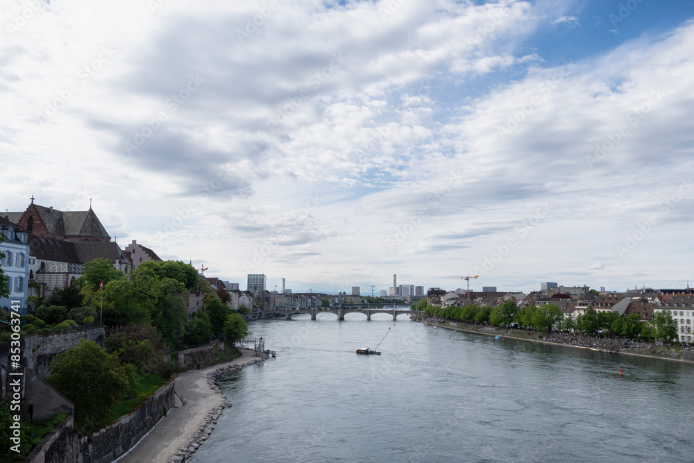 Basel, view from Wettsteinbrucke on the Rhine and Mittlere Rheinbrucke (2024). with river crossing under a cloudy sky. Basel, view from Wettsteinbrucke on the Rhine and Mittlere Rheinbrucke (2024). with river crossing under a cloudy sky.