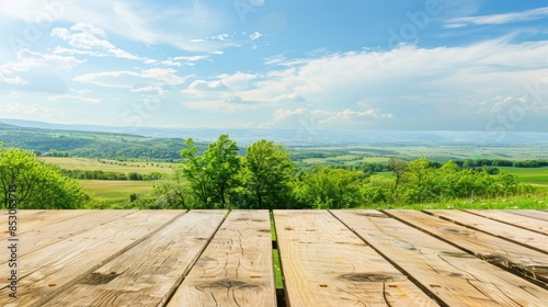 An empty wooden table top for product advertising with an idyllic view of the countryside with green nature