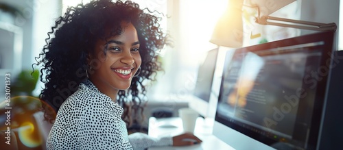 Office scene with a young woman, her white and black curly hair a stark contrast against the brightly lit background. photo