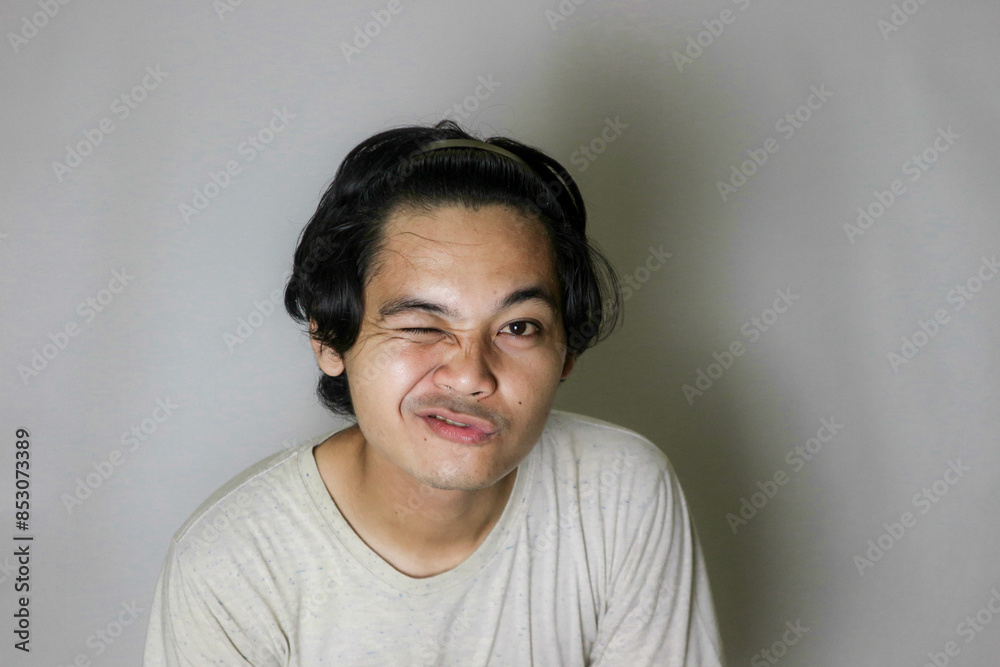 portrait of an Asian Indonesian man posing with random expressions on an isolated white background and white shirt portrait of an Asian Indonesian man posing with random expressions on an isolated white background and white shirt