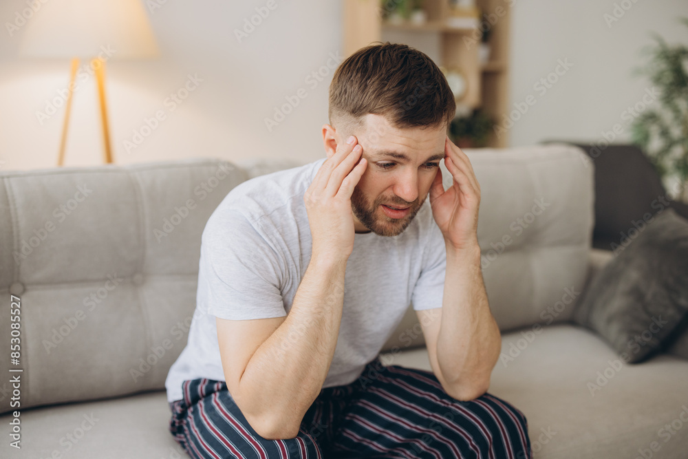 Depressed hopeless man in home wear lying on sofa during mental breakdown, psychotherapy, banner Depressed hopeless man in home wear lying on sofa during mental breakdown, psychotherapy, banner