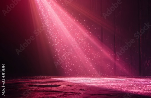 A pink spotlight shines down from the top left corner of an empty stage, creating beautiful sparkles on black background