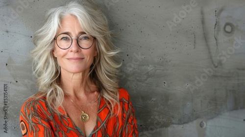 Woman in Glasses Standing by Concrete Wall