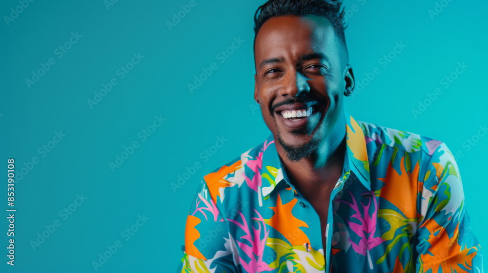 Happy Brazilian man in a bright shirt posing on a blue background. Young African American man having fun indoors. Lifestyle. Happy Brazilian man in a bright shirt posing on a blue background. Young African American man having fun indoors. Lifestyle.