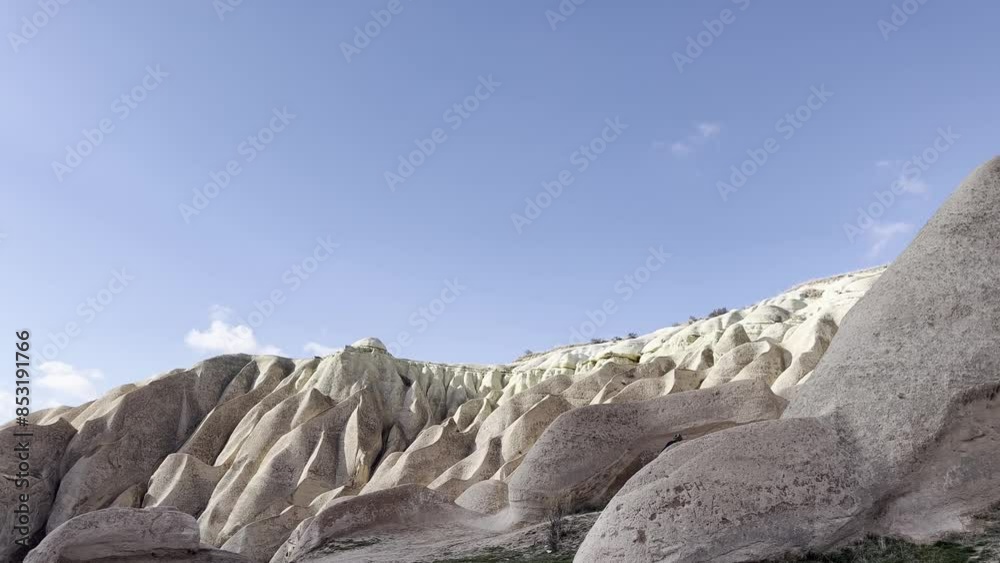 Male walking at winter in Cappadocia region in Turkey by caves in mountain Male walking at winter in Cappadocia region in Turkey by caves in mountain