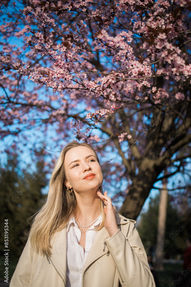 Woman with cherry flowers surrounded by blossoming trees copy space. Beauty and seasonal change and spring bloom season concept. Woman with cherry flowers surrounded by blossoming trees copy space. Beauty and seasonal change and spring bloom season concept.