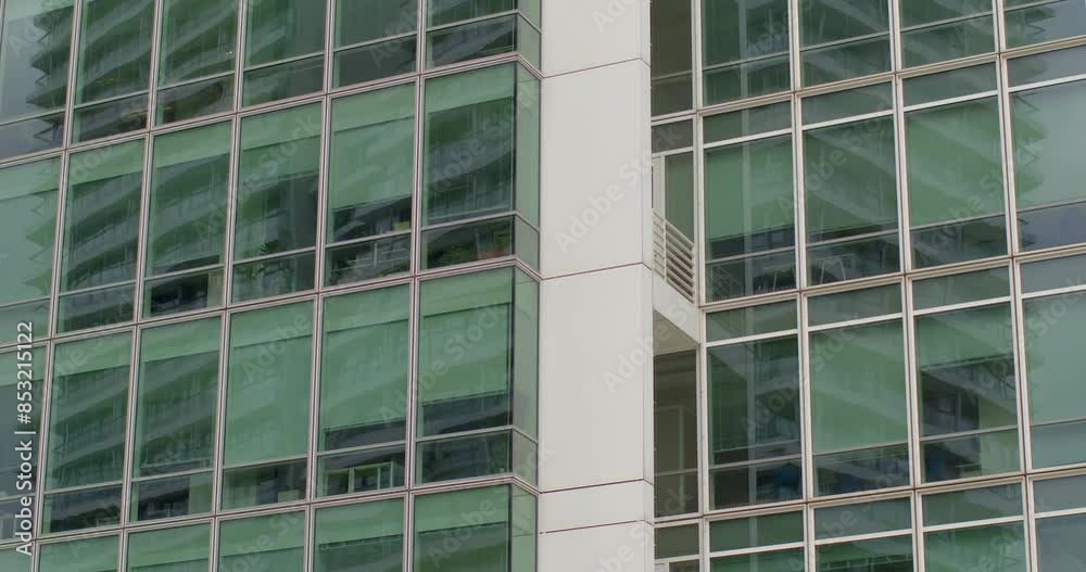 Exterior of contemporary high-rise office building. Floor-to-ceiling glass windows. Concept of modern architecture, corporate environment, and urban skyline. Urban background. Exterior of contemporary high-rise office building. Floor-to-ceiling glass windows. Concept of modern architecture, corporate environment, and urban skyline. Urban background.