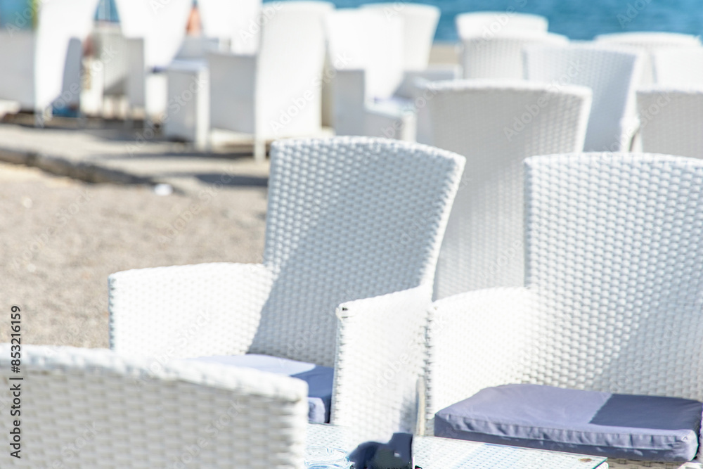Obraz premium White Wicker Chairs on a Beachside Patio in town Opatija