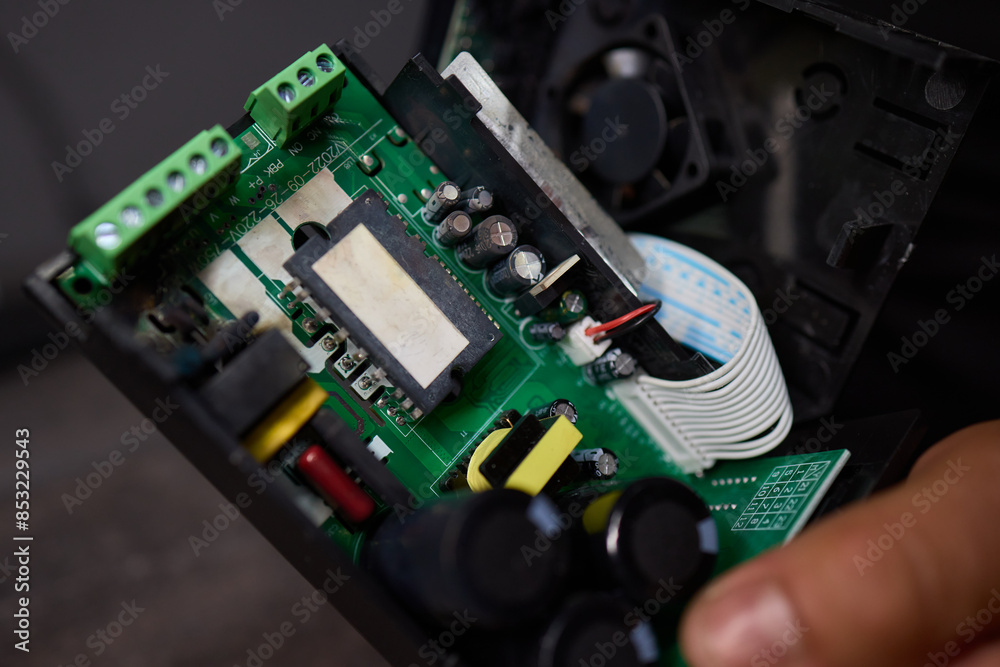 Fototapeta premium burnt Electronic circuit board with cooling fan and ribbon cable for hardware technology