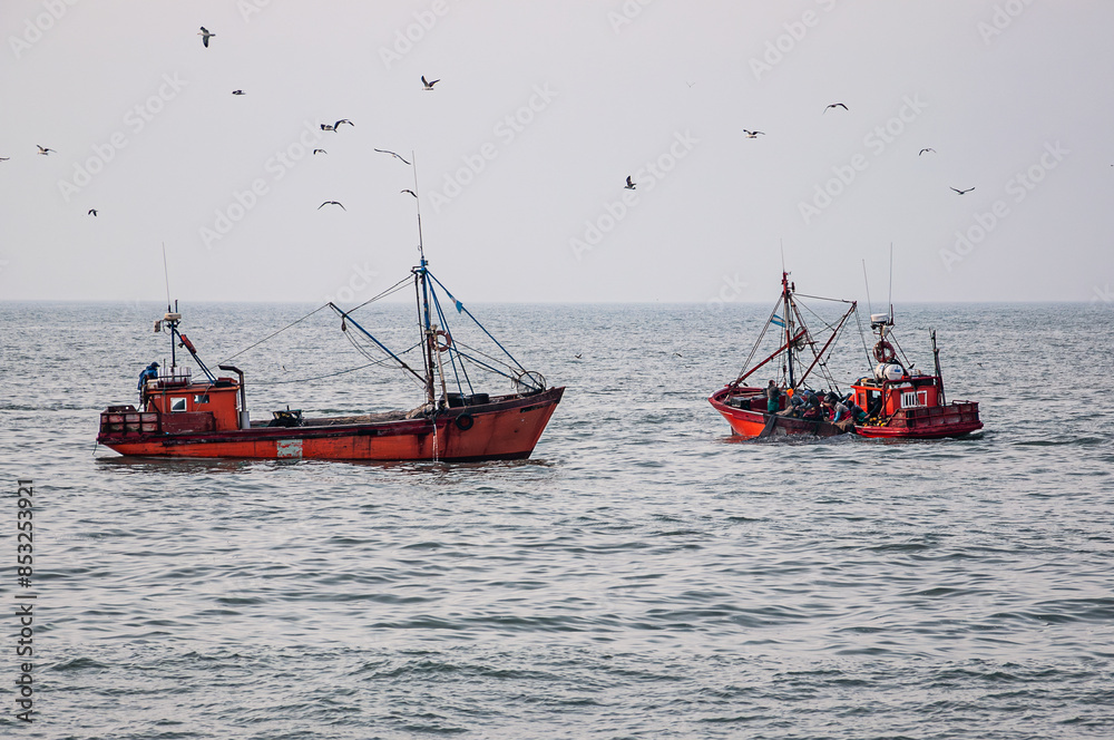 Two small fishing boats fishing off the coast of Mar del Plata Two small fishing boats fishing off the coast of Mar del Plata