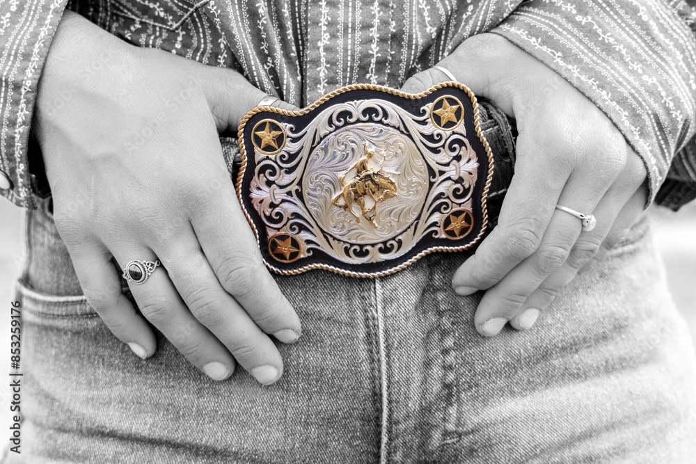 Close-up of a rodeo belt buckle worn by a female ranch hand, or cowgirl.