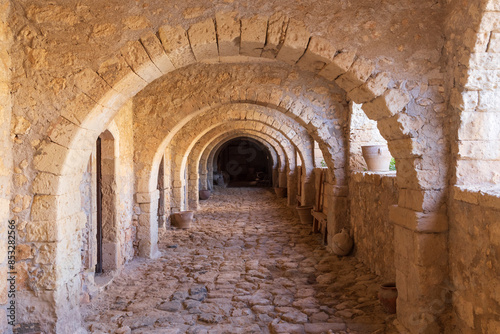 Europe, Greece, Crete, Rethymno. Venetian Baroque, 16th C. Eastern Orthodox Monastery.  The Holy Monastery of Arkadi. Arched stone passageway.