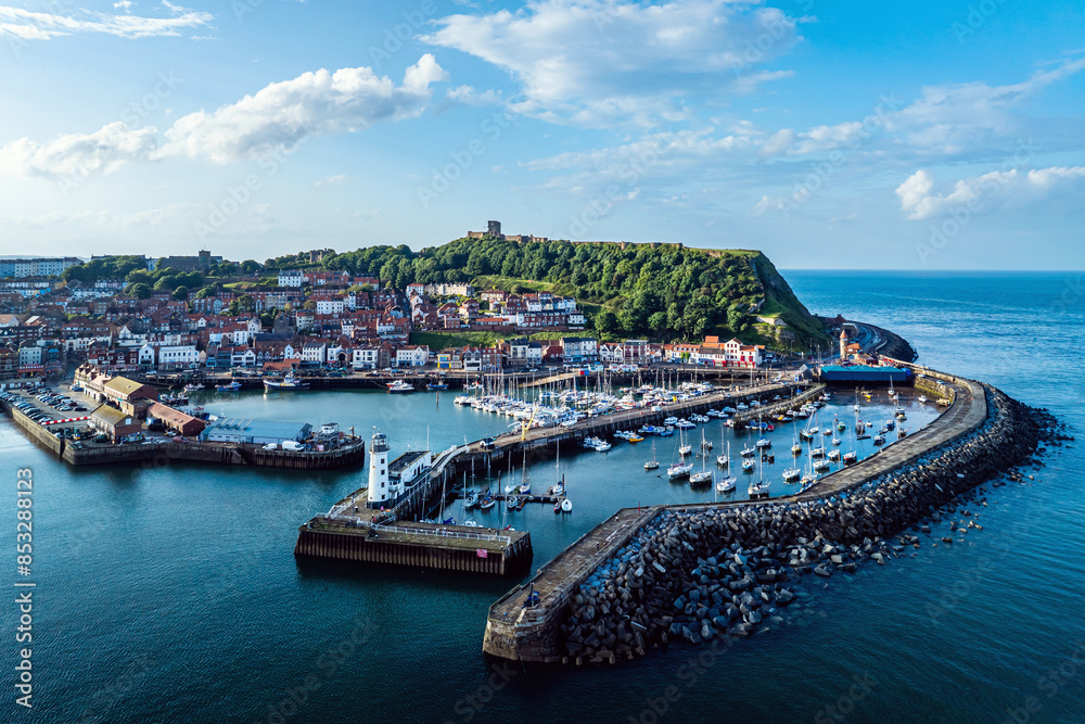 Naklejka premium Scarborough Lighthouse and Harbour from a drone, Vincent Pier, Scarborough, North Yorkshire, England, Europe
