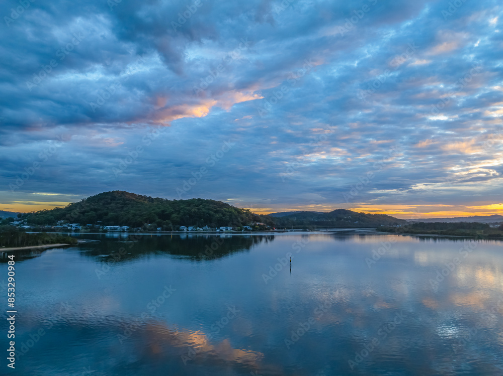 Sunrise over the bay water with clouds and reflections Sunrise over the bay water with clouds and reflections