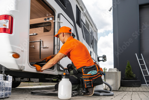 Foto Camper Rentals Worker Cleaning RV Interior With Vacuum