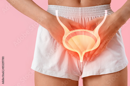 Young woman having menstrual cramps on pink background, closeup photo