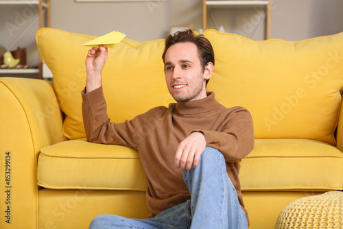 Young man throwing paper pl...