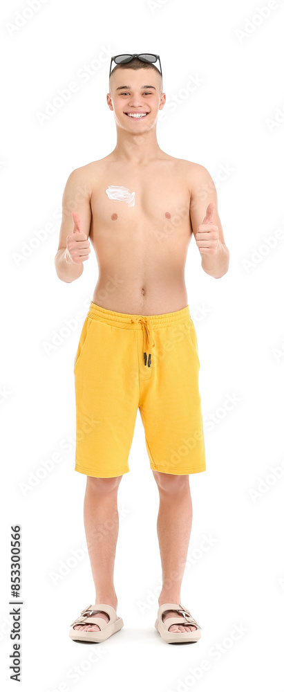 Happy young man in sunglasses with sunscreen cream on his body showing thumbs-up against white background Happy young man in sunglasses with sunscreen cream on his body showing thumbs-up against white background
