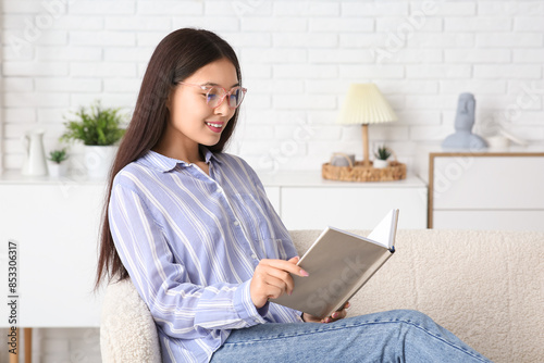 Young happy Asian woman in ...